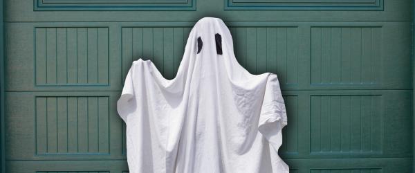 Ghost standing in front of garage door